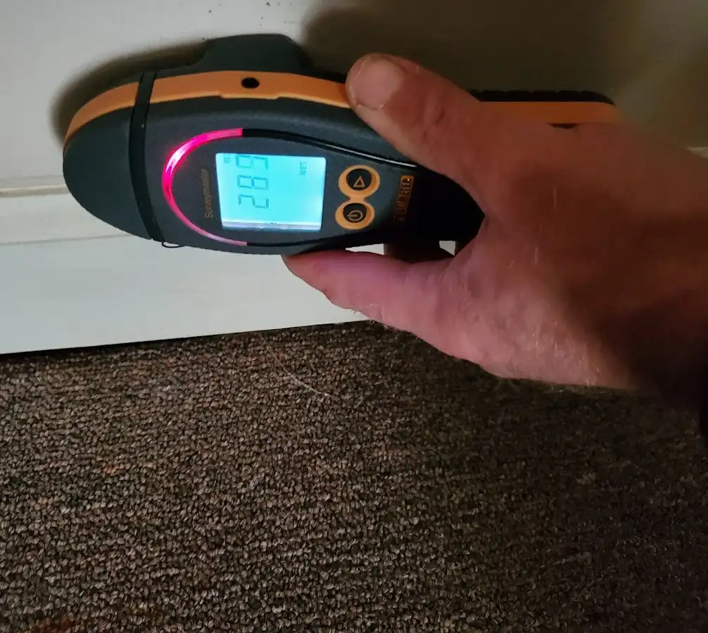 Moisture detection at baseboard during Storm Damage Restoration in Amityville
